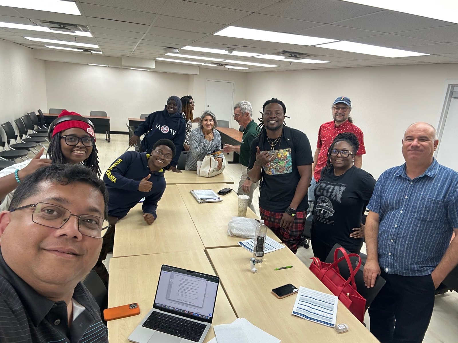 Educators and the project team gathered around a table during RAOP 2026.